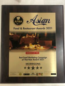 A photograph of the afra award for best food marketing campain, which is a gold plaque.