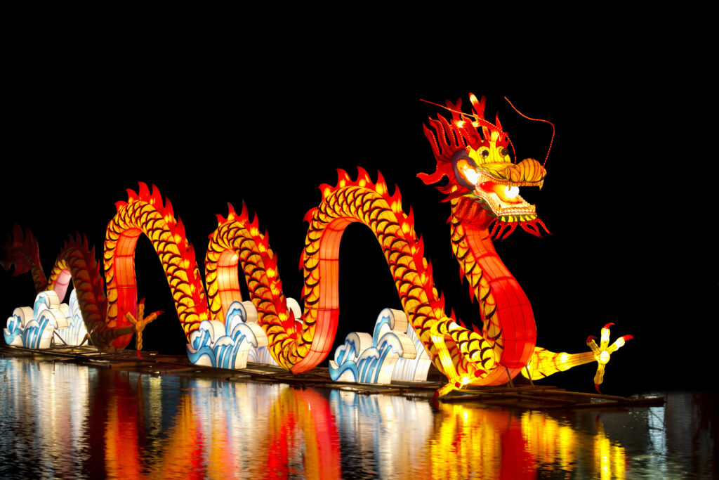 a dragon shaped lantern on a dark background for the lantern festival in the uk