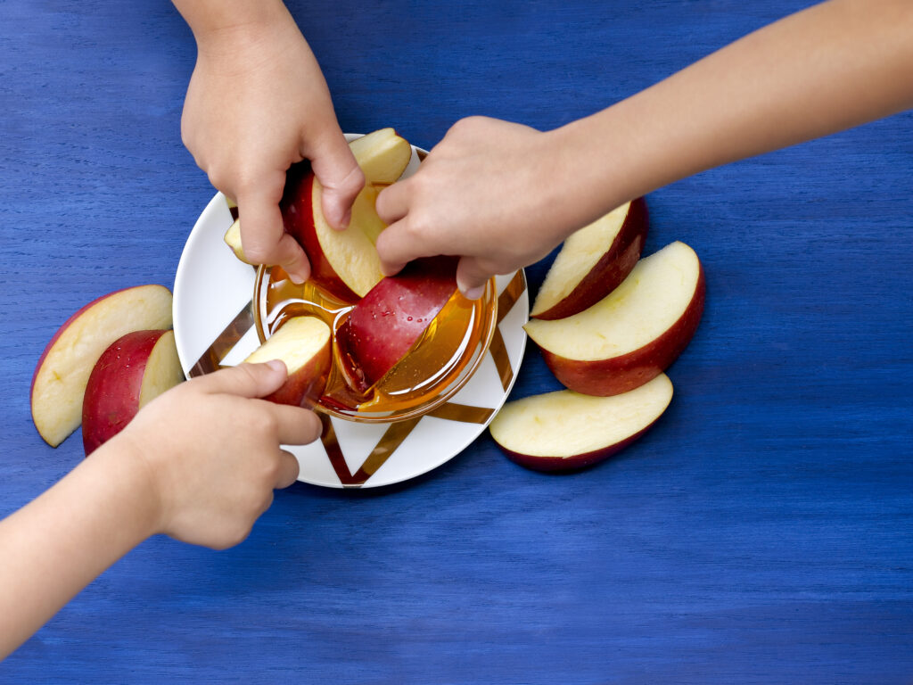 Apples being dipped in honey