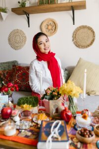 woman celebrating nowruz with haft sin table